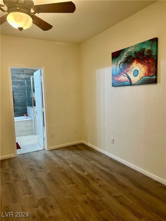 spare room featuring wood-type flooring and ceiling fan