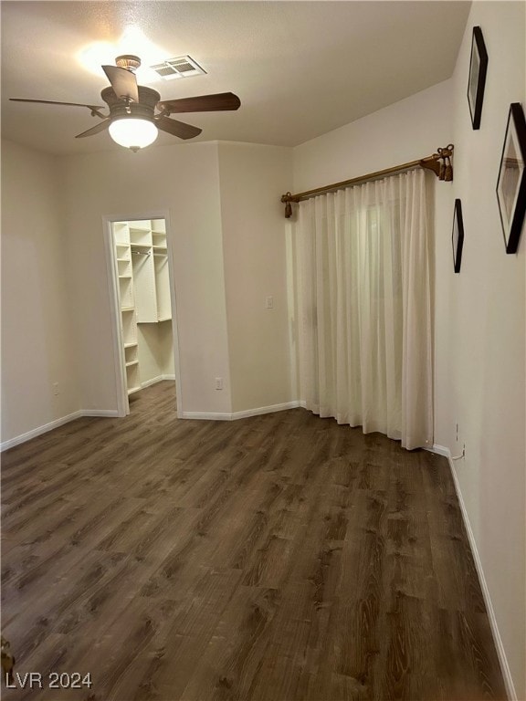 empty room featuring dark hardwood / wood-style flooring and ceiling fan