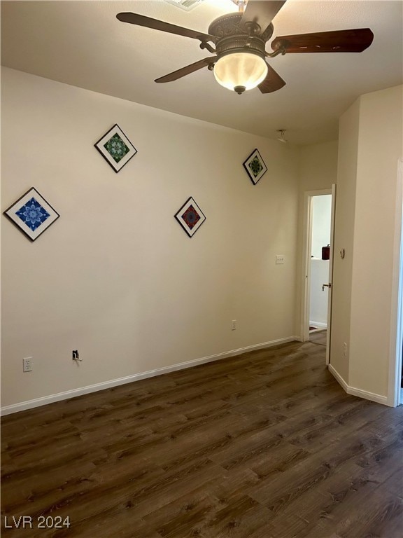 unfurnished room with dark hardwood / wood-style flooring and ceiling fan