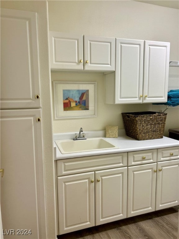 kitchen featuring white cabinetry, sink, and dark hardwood / wood-style floors