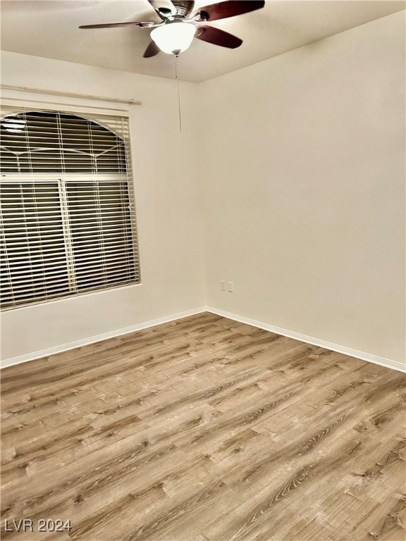 spare room featuring hardwood / wood-style flooring and ceiling fan