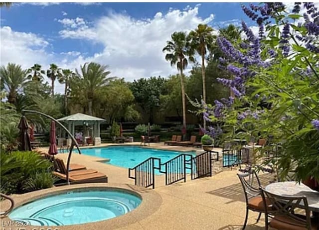 view of pool featuring a patio, a community hot tub, and a gazebo