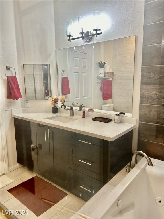 bathroom with vanity, tile patterned floors, toilet, and a notable chandelier