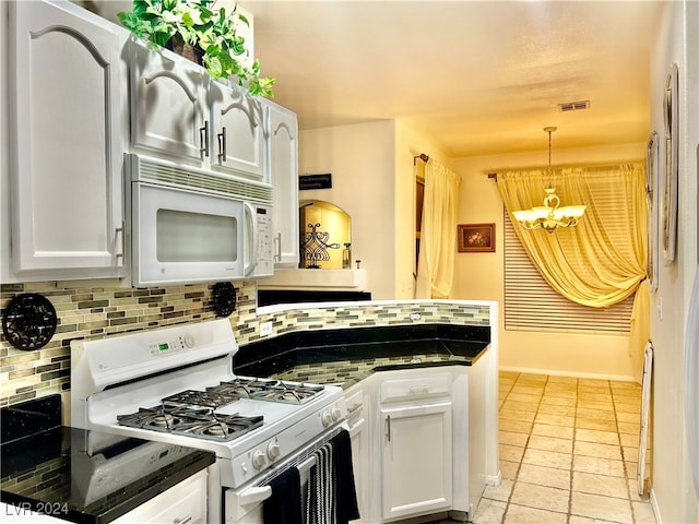 kitchen featuring white appliances, a chandelier, white cabinets, pendant lighting, and decorative backsplash