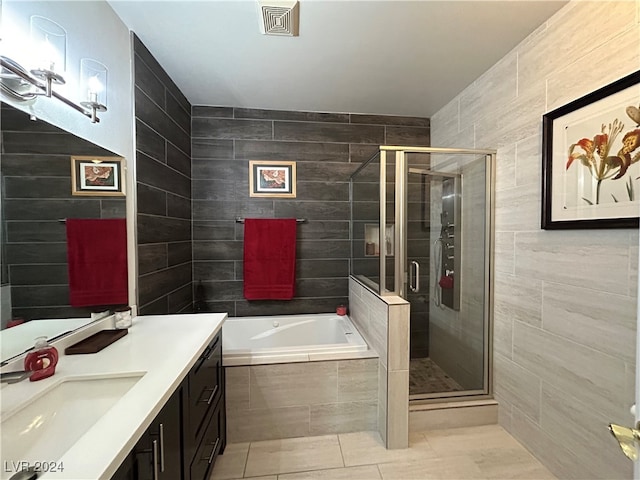 bathroom featuring tile walls, tile patterned flooring, vanity, and separate shower and tub