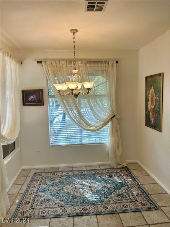 unfurnished dining area with a chandelier and a healthy amount of sunlight