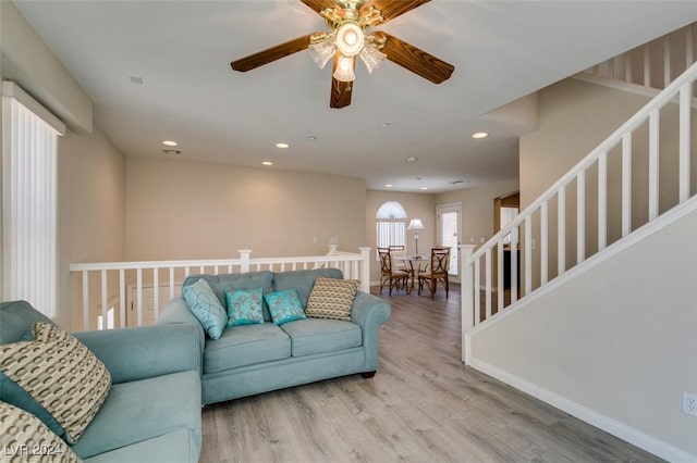 living room with wood-type flooring and ceiling fan