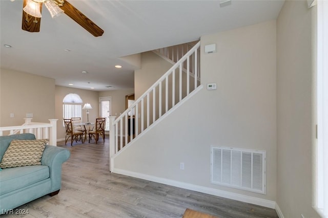 living room with ceiling fan and light wood-type flooring