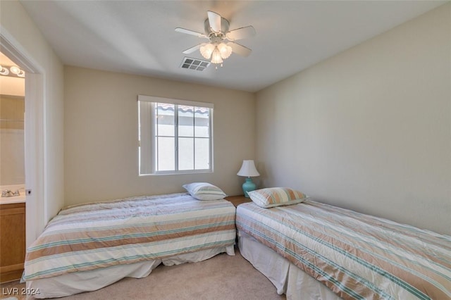 bedroom with ceiling fan, connected bathroom, and carpet floors