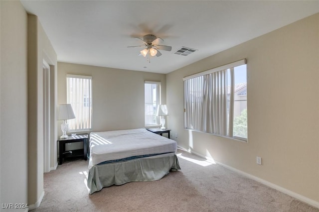 bedroom with light carpet and ceiling fan