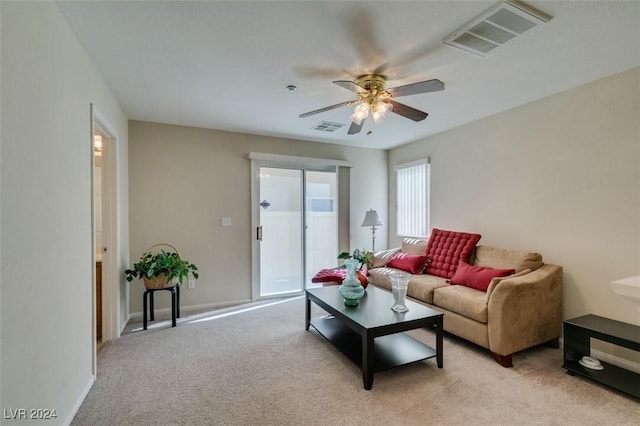 carpeted living room with ceiling fan