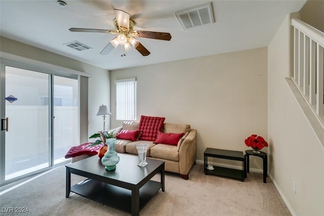 carpeted living room featuring ceiling fan