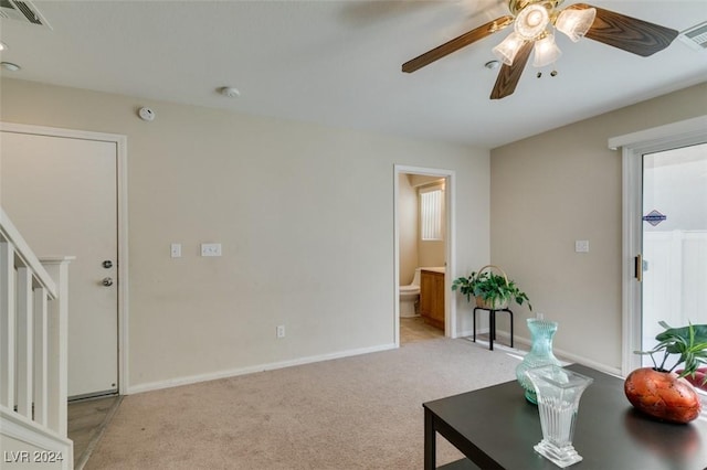 living room featuring light carpet and ceiling fan