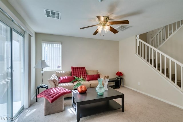 carpeted living room featuring ceiling fan