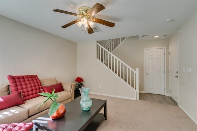 living room with light carpet and ceiling fan