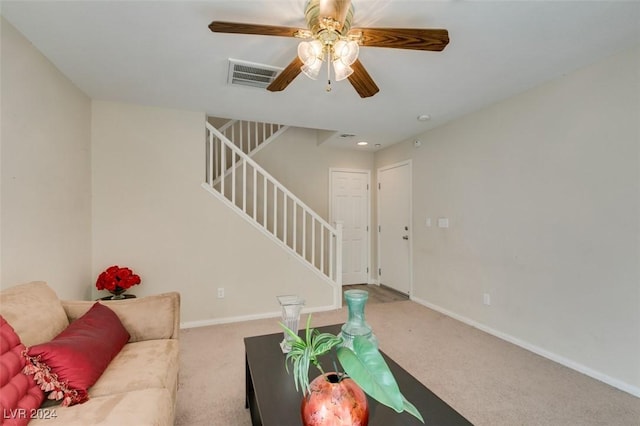 carpeted living room with ceiling fan