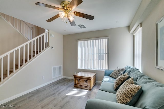 living room with ceiling fan and light wood-type flooring