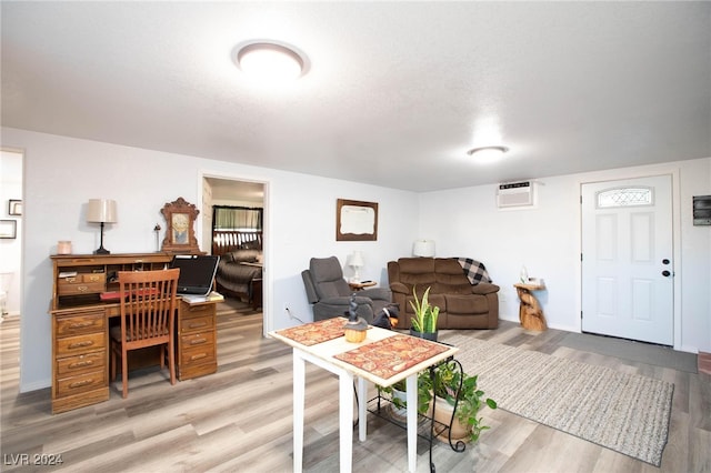 living room featuring hardwood / wood-style flooring and a wall unit AC