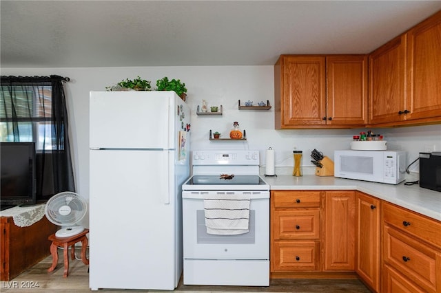 kitchen with white appliances and dark hardwood / wood-style floors