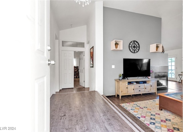 living room with wood-type flooring and vaulted ceiling