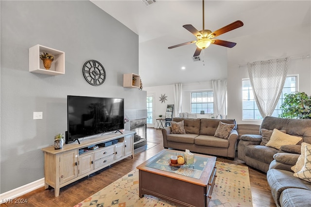 living room with ceiling fan, hardwood / wood-style floors, and high vaulted ceiling