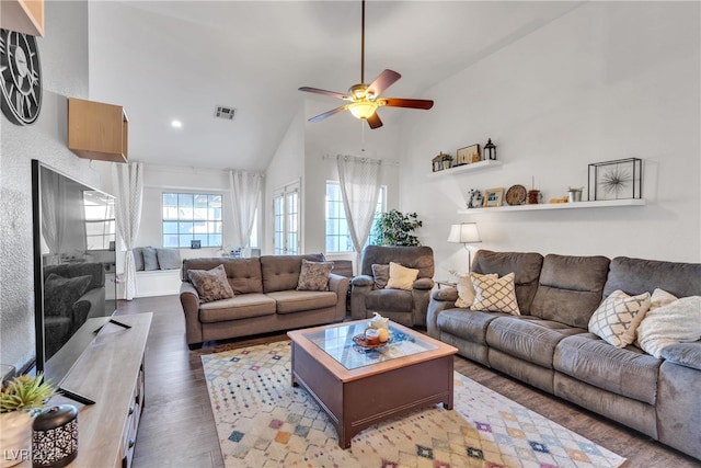 living room featuring vaulted ceiling, ceiling fan, and dark wood-type flooring