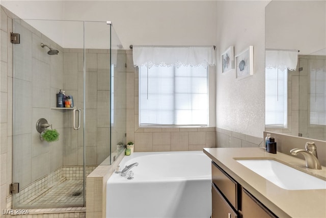 bathroom featuring separate shower and tub and vanity