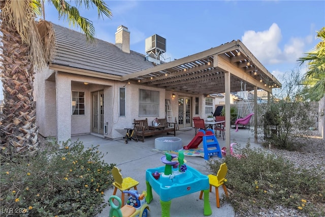 back of house featuring a pergola, cooling unit, and a patio area