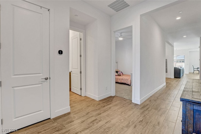 hall with light hardwood / wood-style floors