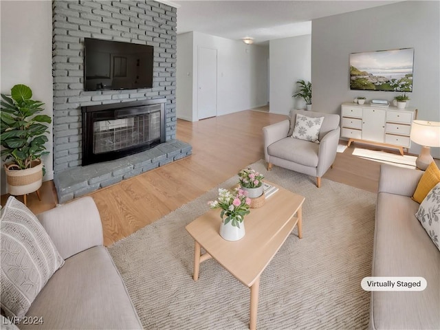 living room featuring a fireplace and light hardwood / wood-style flooring