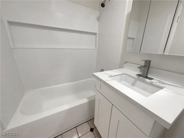 bathroom featuring tile patterned flooring, vanity, and  shower combination