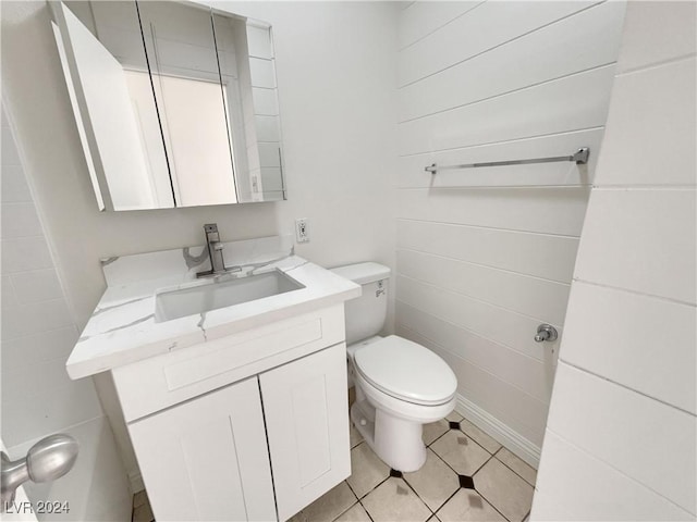 bathroom featuring tile patterned flooring, vanity, and toilet