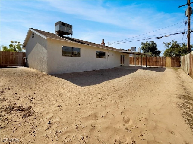 back of house featuring central AC unit