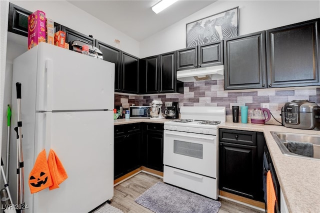 kitchen featuring sink, decorative backsplash, light wood-type flooring, and white appliances