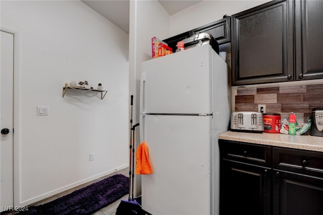 kitchen featuring light tile patterned floors and white refrigerator