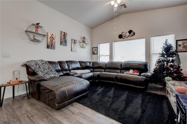 living room with lofted ceiling, hardwood / wood-style flooring, and ceiling fan