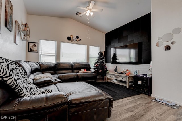 living room with light hardwood / wood-style floors, lofted ceiling, and ceiling fan