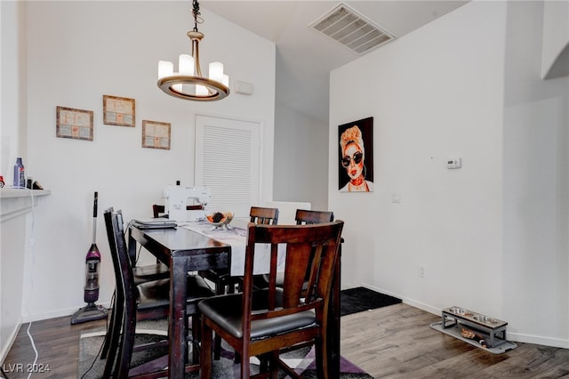 dining space with an inviting chandelier and hardwood / wood-style flooring