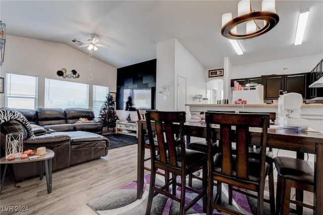 dining space with light hardwood / wood-style floors, lofted ceiling, and ceiling fan