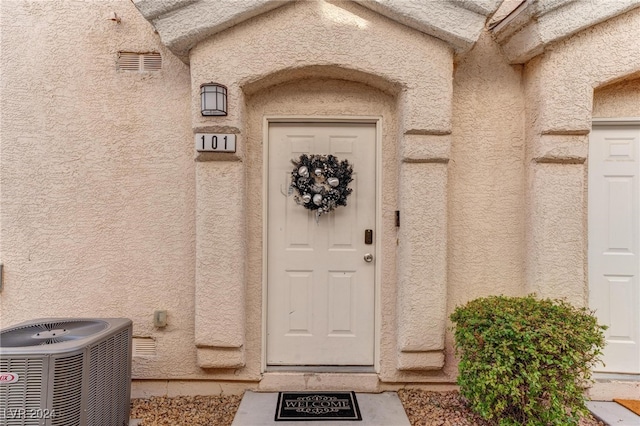 doorway to property with central AC unit