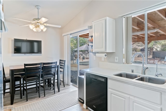 kitchen featuring dishwasher, light hardwood / wood-style flooring, sink, vaulted ceiling, and white cabinetry