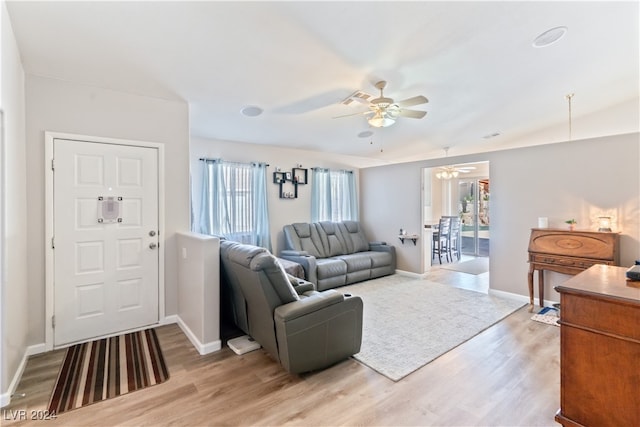 living room with light hardwood / wood-style flooring and ceiling fan