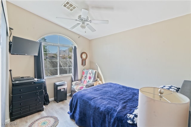 bedroom with light hardwood / wood-style floors and ceiling fan