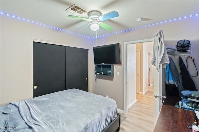 bedroom featuring a closet, hardwood / wood-style flooring, and ceiling fan