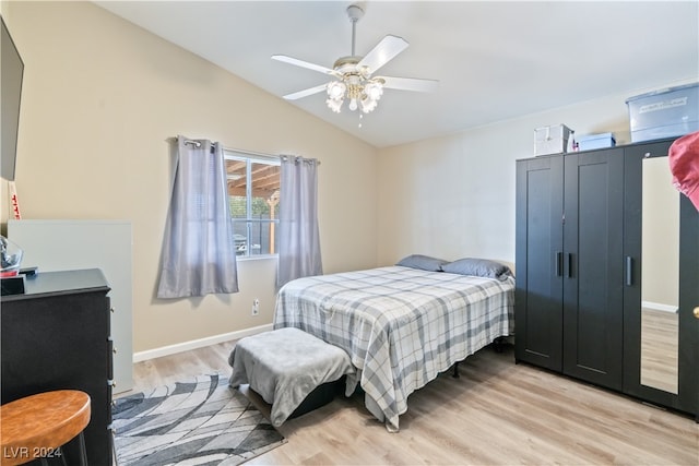 bedroom with lofted ceiling, light hardwood / wood-style floors, and ceiling fan