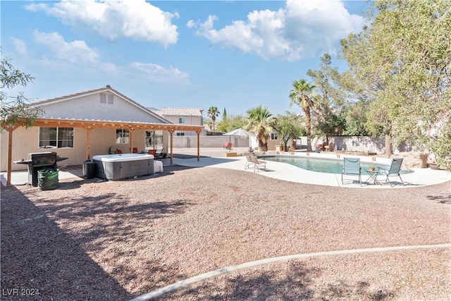 exterior space with a patio and a pool with hot tub