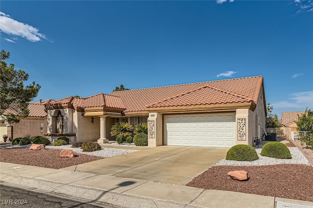 mediterranean / spanish home with a garage