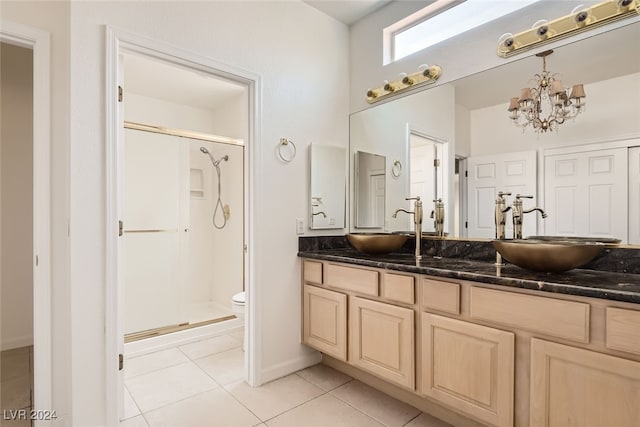 bathroom featuring a shower with shower door, toilet, vanity, a notable chandelier, and tile patterned flooring