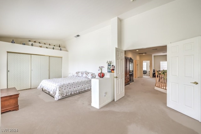 carpeted bedroom featuring a closet and lofted ceiling