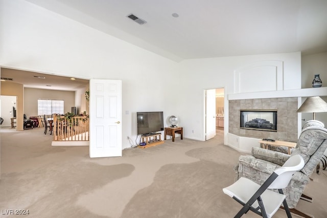 living room featuring carpet flooring and a tile fireplace